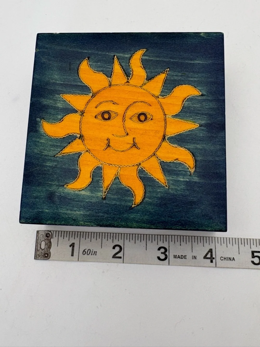 Bright Yellow Sun on Deep Blue Wooden Box